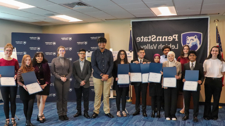 Students posing with awards